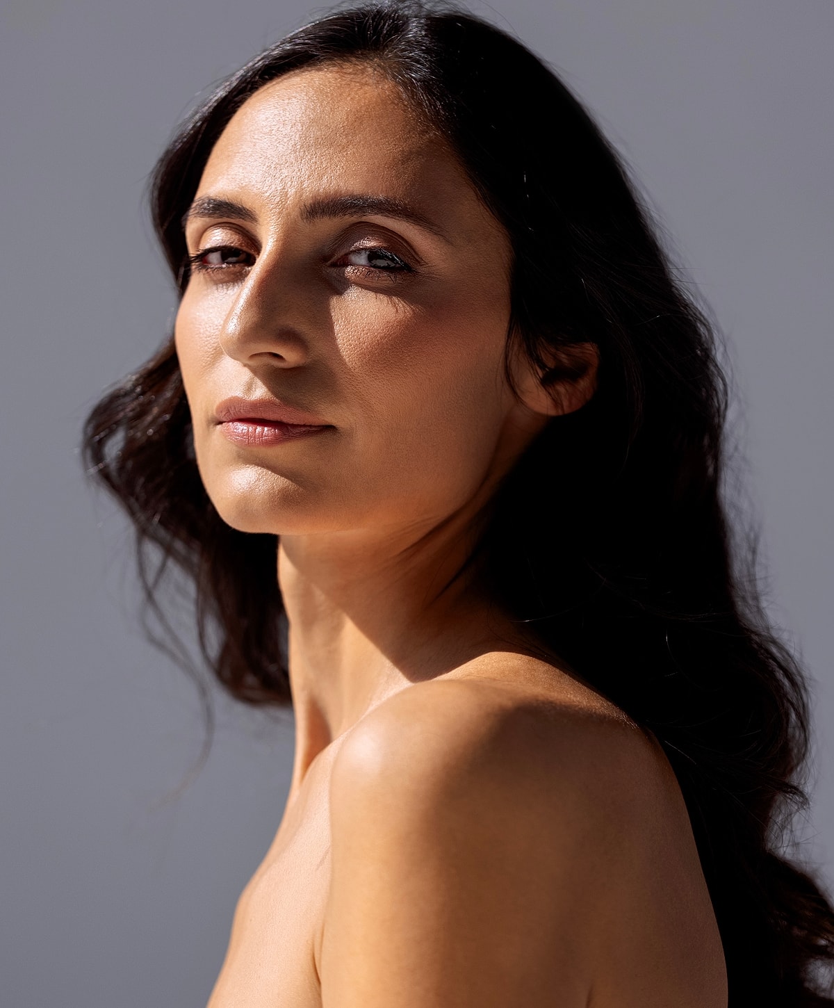 Tucson Blepharoplasty model enjoying a sunny moment outdoors.