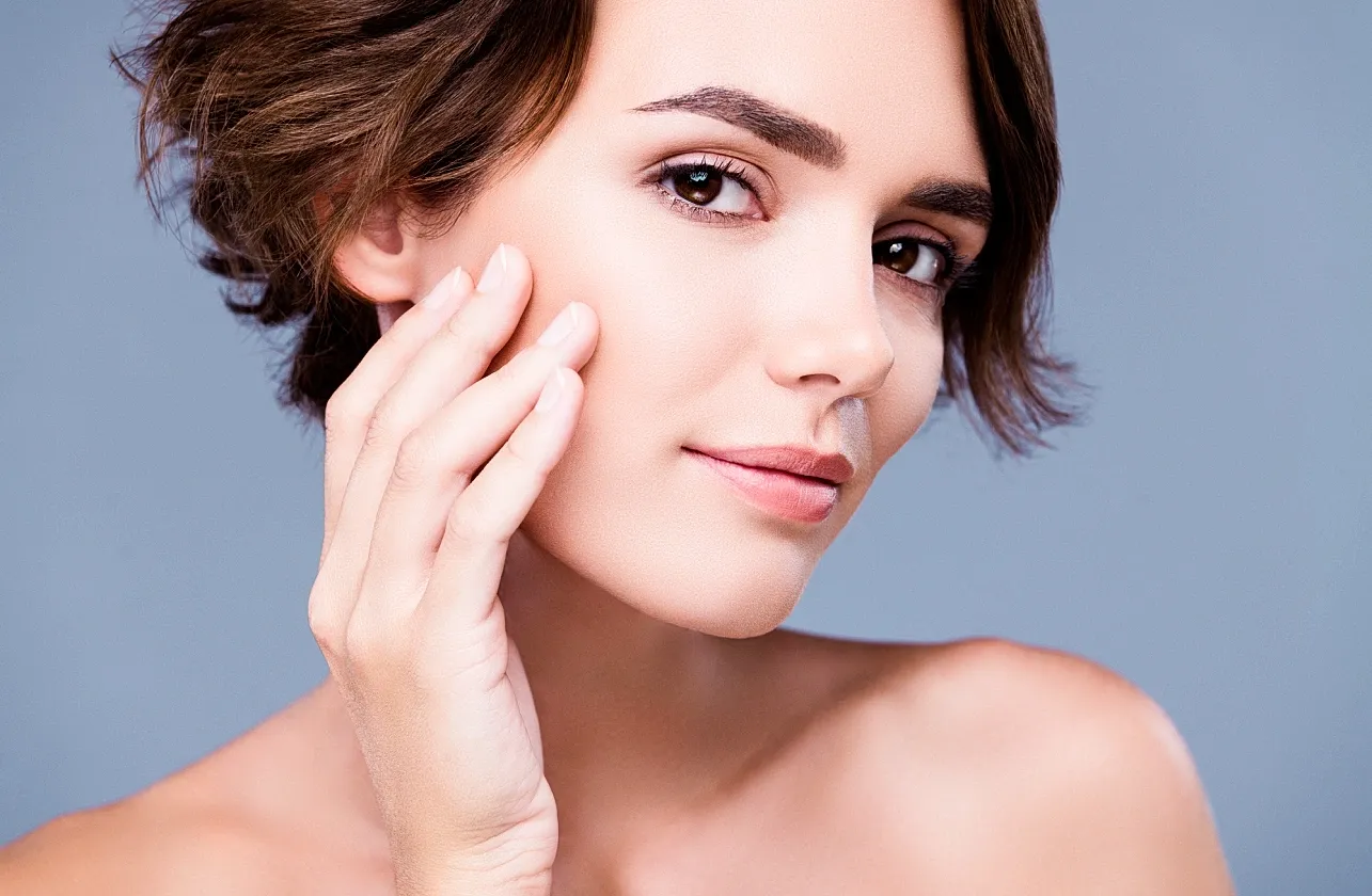 Tucson Botox model touching her face.