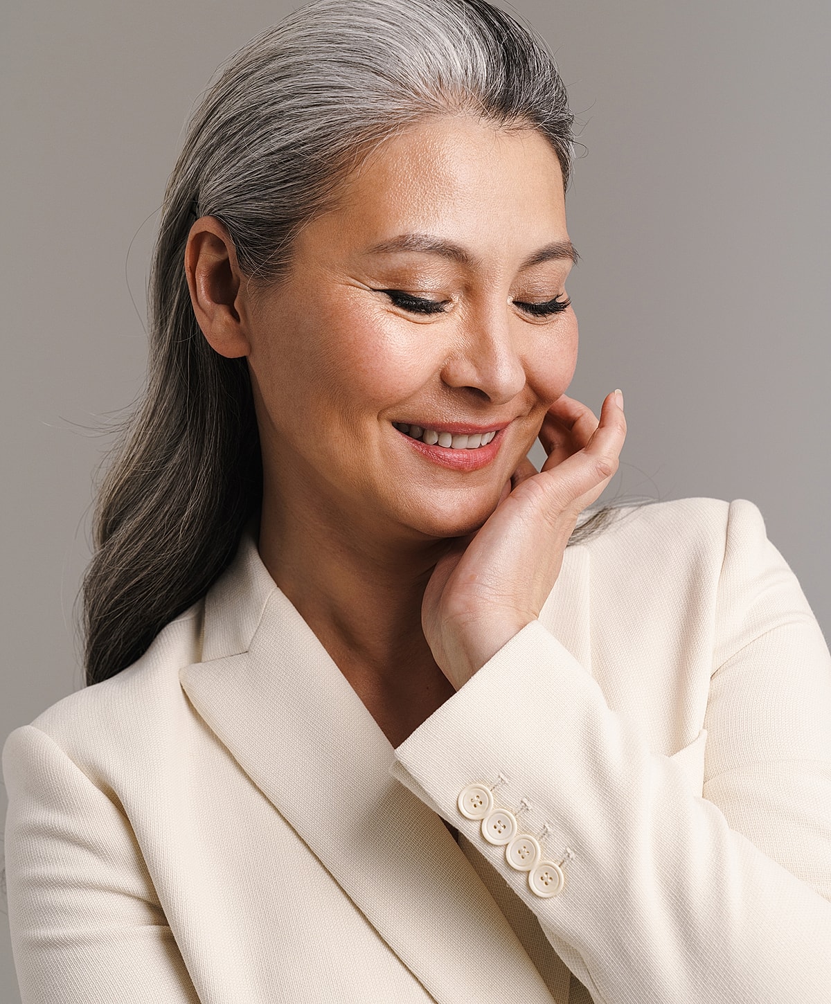 Tucson Facelift model with gray hair, wearing a blazer.