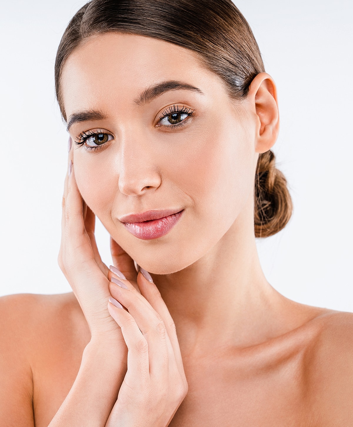 Woman touching her face with a gentle expression.