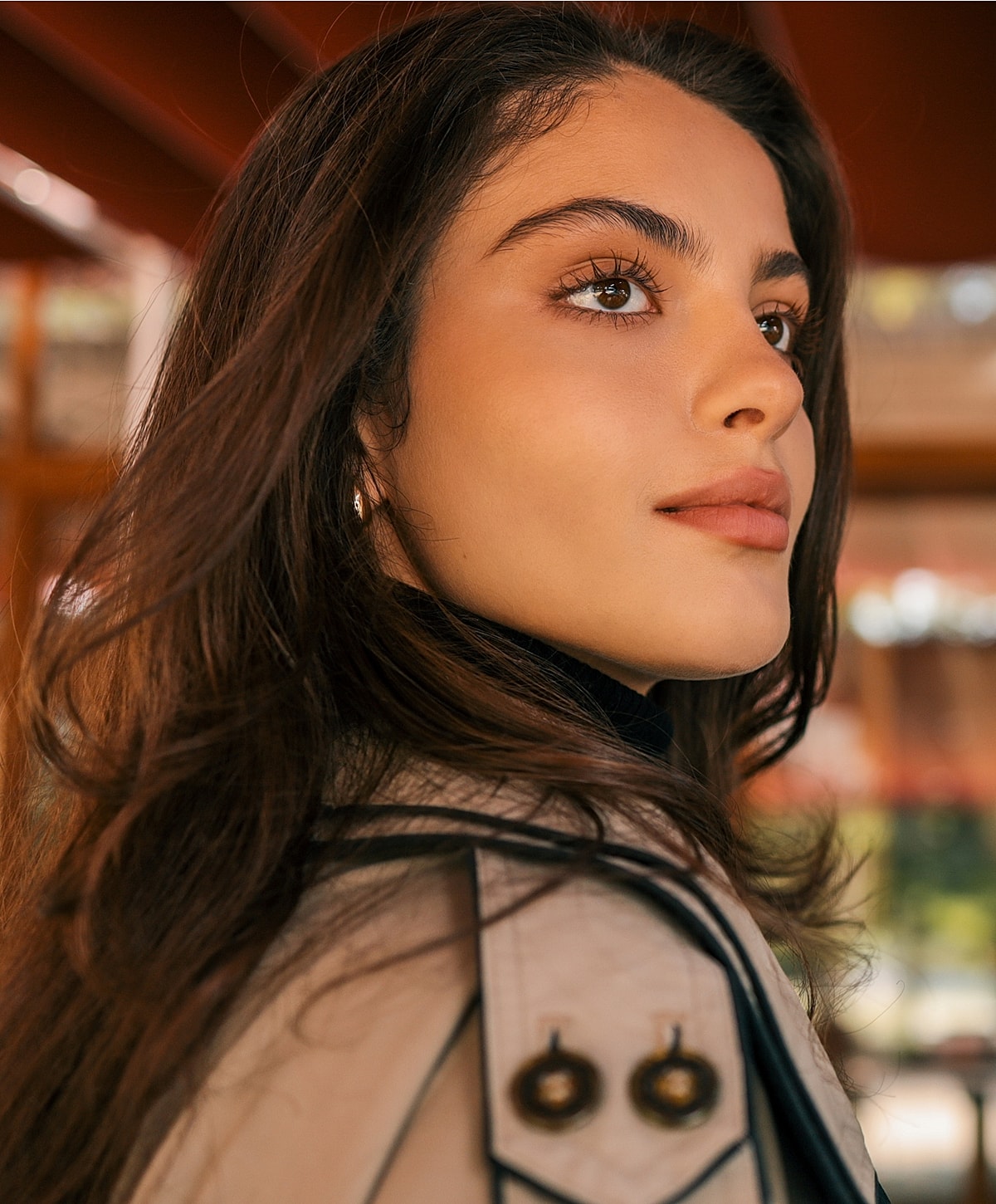 Tucson Restylane model with long hair, wearing a stylish coat.