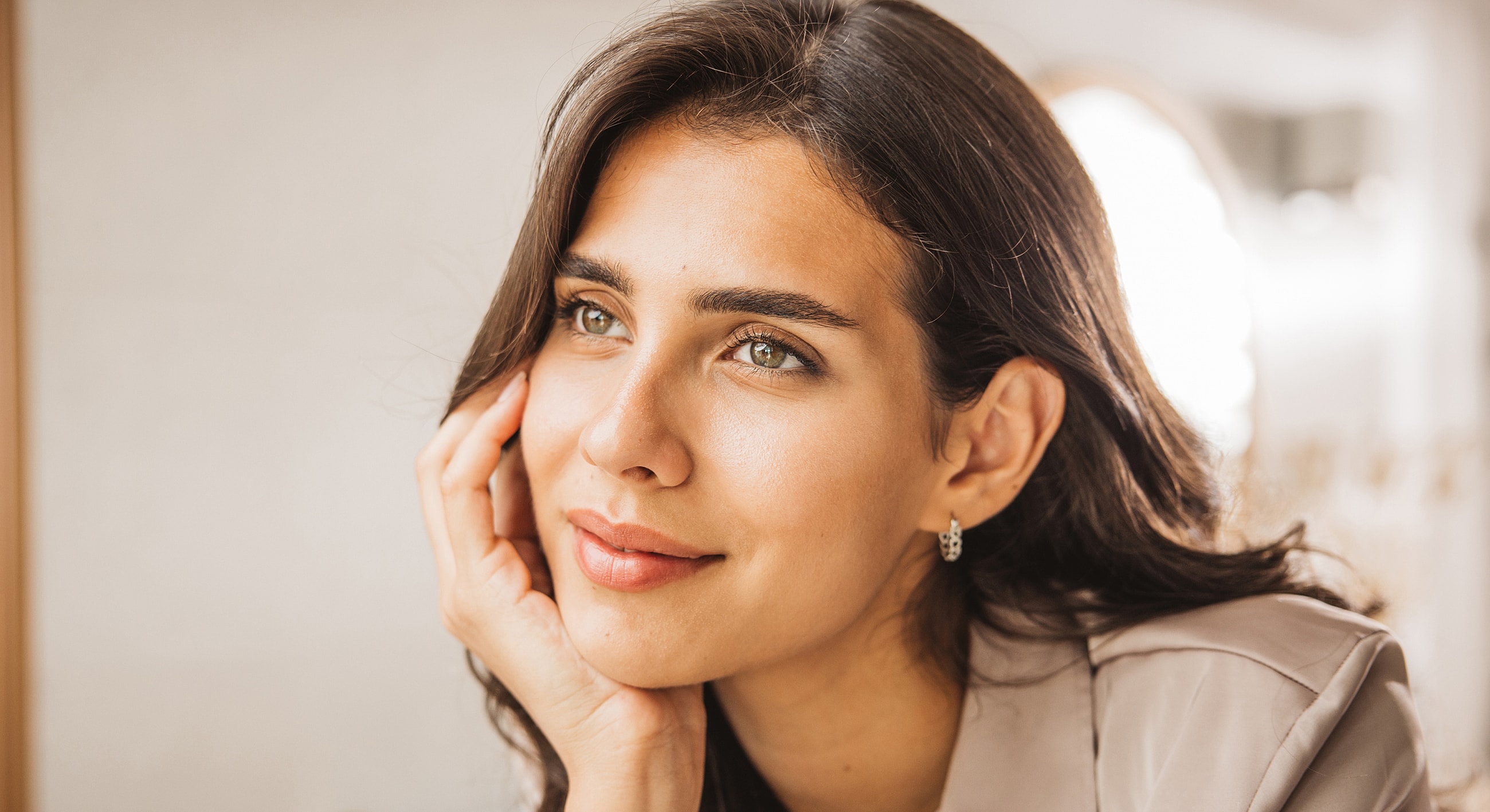 Tucson Restylane model thoughtfully resting her chin on her hand.